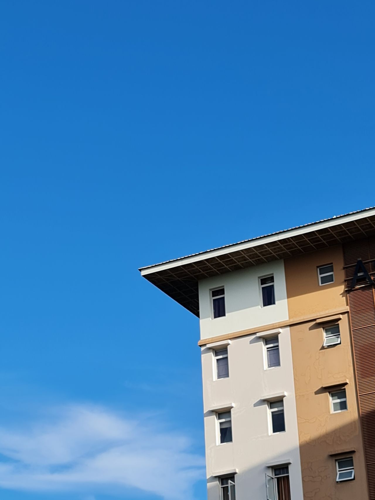 Modern apartment building against a clear blue sky